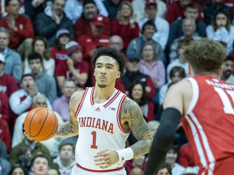 Jan 14, 2023; Bloomington, Indiana, USA; Indiana Hoosiers guard Jalen Hood-Schifino (1) dribbles the ball while Wisconsin Badgers guard Max Klesmit (11) defends in the first half at Simon Skjodt Assembly Hall. Mandatory Credit: Trevor Ruszkowski-USA TODAY Sports