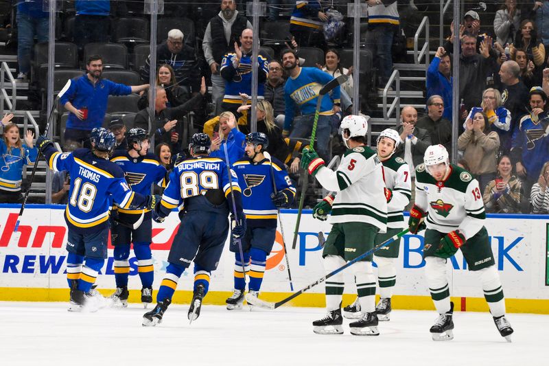 Nov 19, 2024; St. Louis, Missouri, USA;  St. Louis Blues left wing Jake Neighbours (63) is congratulated by teammates after scoring against the Minnesota Wild during the third period at Enterprise Center. Mandatory Credit: Jeff Curry-Imagn Images