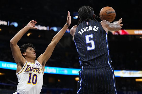 ORLANDO, FLORIDA - NOVEMBER 04: Paolo Banchero #5 of the Orlando Magic throws a pass against Max Christie #10 of the Los Angeles Lakers during the second half at Amway Center on November 04, 2023 in Orlando, Florida. NOTE TO USER: User expressly acknowledges and agrees that, by downloading and or using this photograph, User is consenting to the terms and conditions of the Getty Images License Agreement. (Photo by Rich Storry/Getty Images)