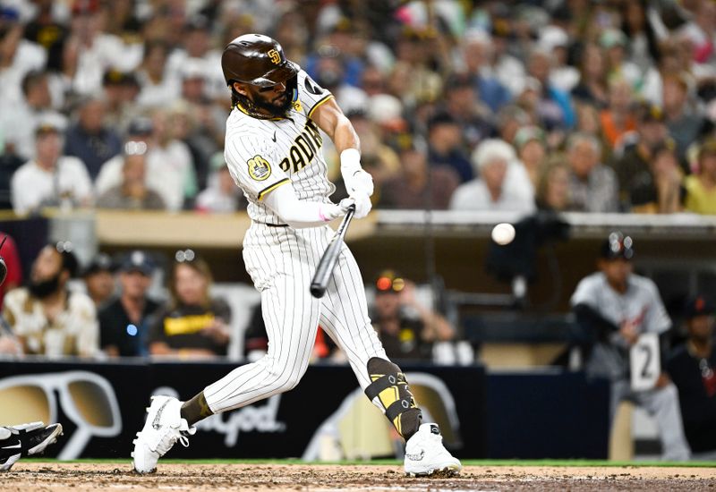 Sep 4, 2024; San Diego, California, USA; San Diego Padres right fielder Fernando Tatis Jr. (23) hits a double during the fifth inning against the Detroit Tigers at Petco Park. Mandatory Credit: Denis Poroy-Imagn Images