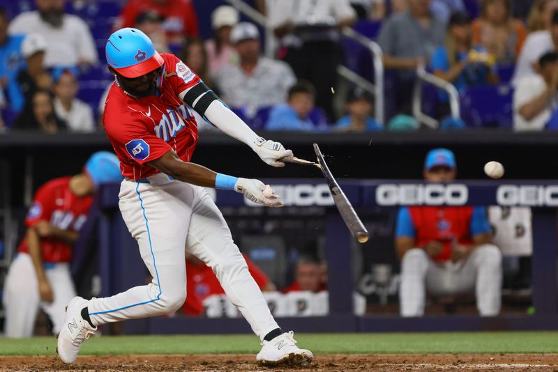 Apr 27, 2024; Miami, Florida, USA; Miami Marlins third baseman Vidal Brujan (17) hits a single against the Washington Nationals during the fourth inning at loanDepot Park. Mandatory Credit: Sam Navarro-USA TODAY Sports