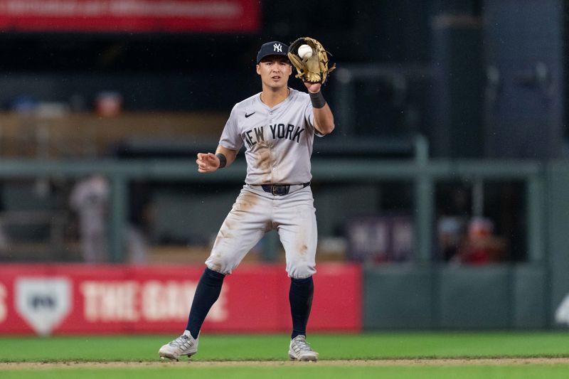 May 15, 2024; Minneapolis, Minnesota, USA; New York Yankees shortstop Anthony Volpe (11) catches a ball thrown after Minnesota Twins first base Carlos Santana (30) strikes out at Target Field. Mandatory Credit: Matt Blewett-USA TODAY Sports