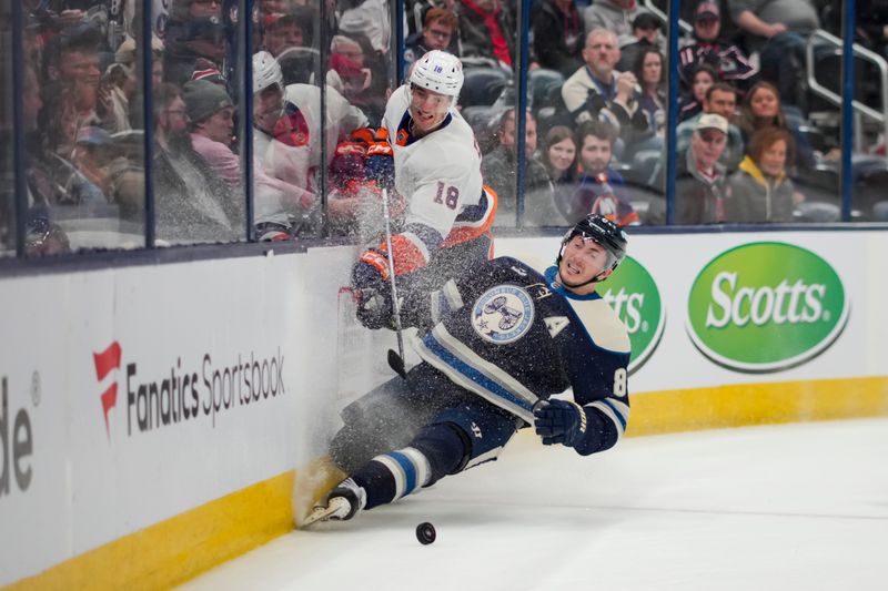 Apr 4, 2024; Columbus, Ohio, USA;  New York Islanders left wing Pierre Engvall (18) collides with Columbus Blue Jackets defenseman Zach Werenski (8) along the boards in the third period at Nationwide Arena. Mandatory Credit: Aaron Doster-USA TODAY Sports