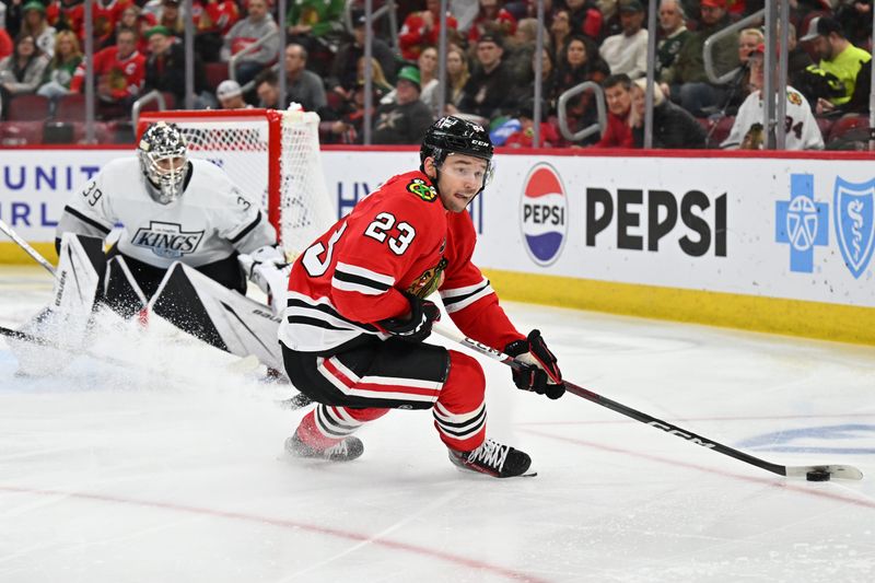 Mar 15, 2024; Chicago, Illinois, USA; Chicago Blackhawks forward Philipp Kurashev (23) controls the puck in front of Los Angeles Kings goaltender Cam Talbot (39) in the second period at United Center. Mandatory Credit: Jamie Sabau-USA TODAY Sports