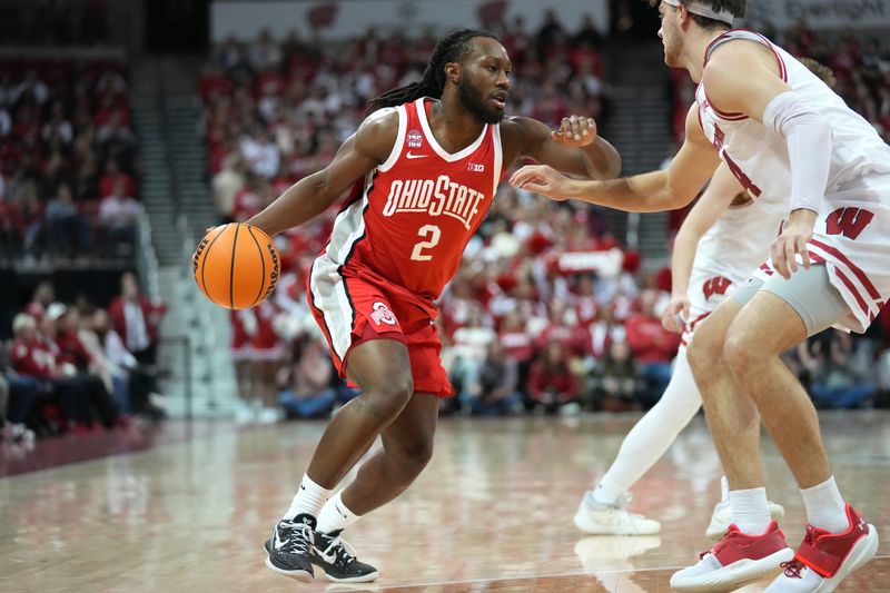 Feb 13, 2024; Madison, Wisconsin, USA;  Ohio State Buckeyes guard Bruce Thornton (2) dribbles the ball against Wisconsin Badgers forward Carter Gilmore (14) during the first half at the Kohl Center. Mandatory Credit: Kayla Wolf-USA TODAY Sports