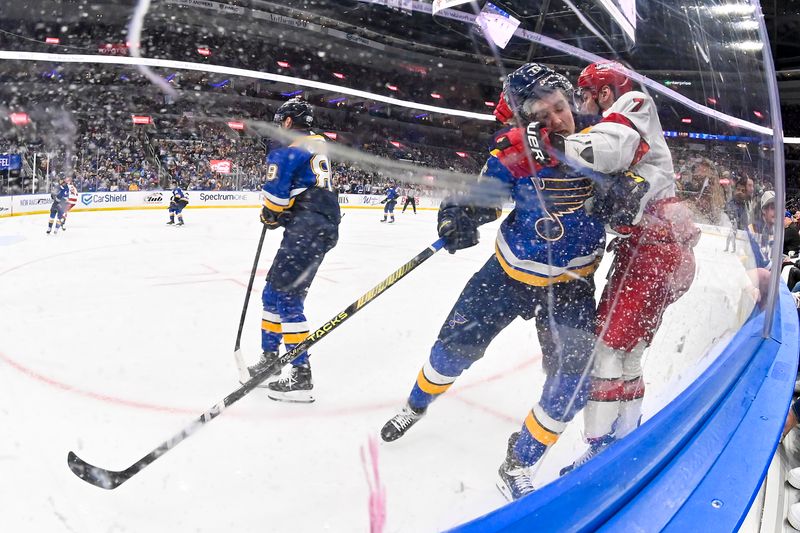 Apr 12, 2024; St. Louis, Missouri, USA;  St. Louis Blues defenseman Tyler Tucker (75) checks Carolina Hurricanes defenseman Dmitry Orlov (7) during the third period at Enterprise Center. Mandatory Credit: Jeff Curry-USA TODAY Sports