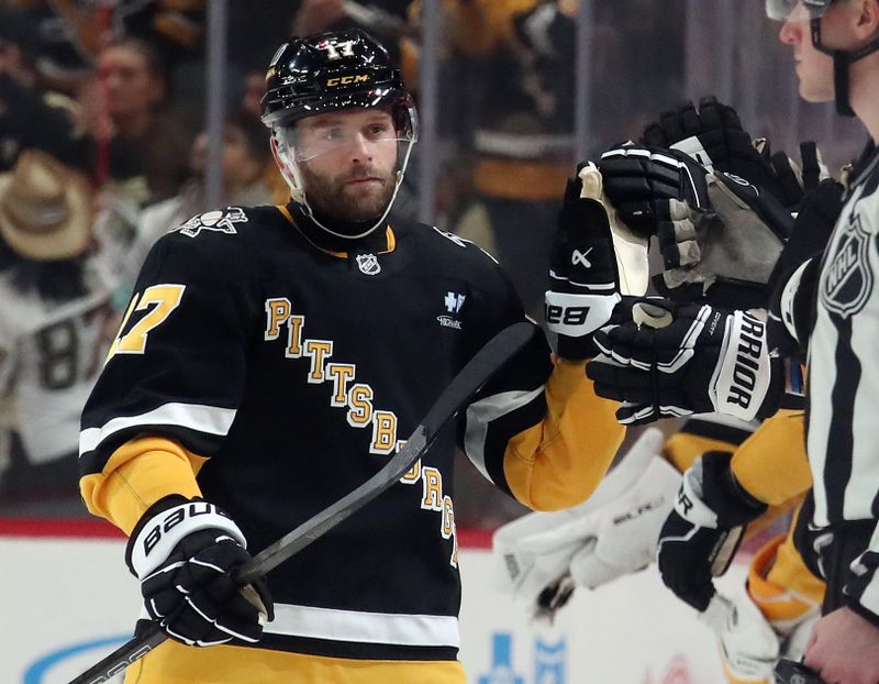 Jan 14, 2025; Pittsburgh, Pennsylvania, USA;  Pittsburgh Penguins right wing Bryan Rust (17) celebrates his goal with the Penguins bench against the Seattle Kraken during the second period at PPG Paints Arena. Mandatory Credit: Charles LeClaire-Imagn Images