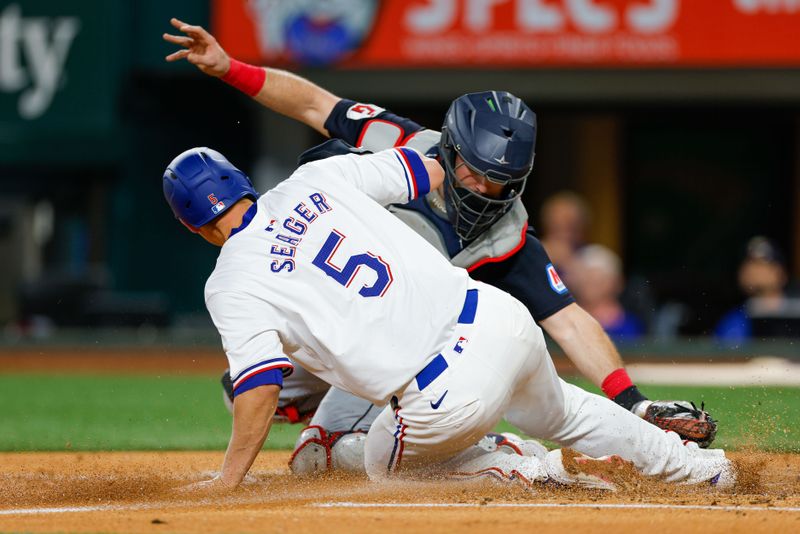 May 15, 2024; Arlington, Texas, USA; Cleveland Guardians catcher Austin Hedges (27) tags Texas Rangers shortstop Corey Seager (5) out at the plate during the fourth inning at Globe Life Field. Mandatory Credit: Andrew Dieb-USA TODAY Sports