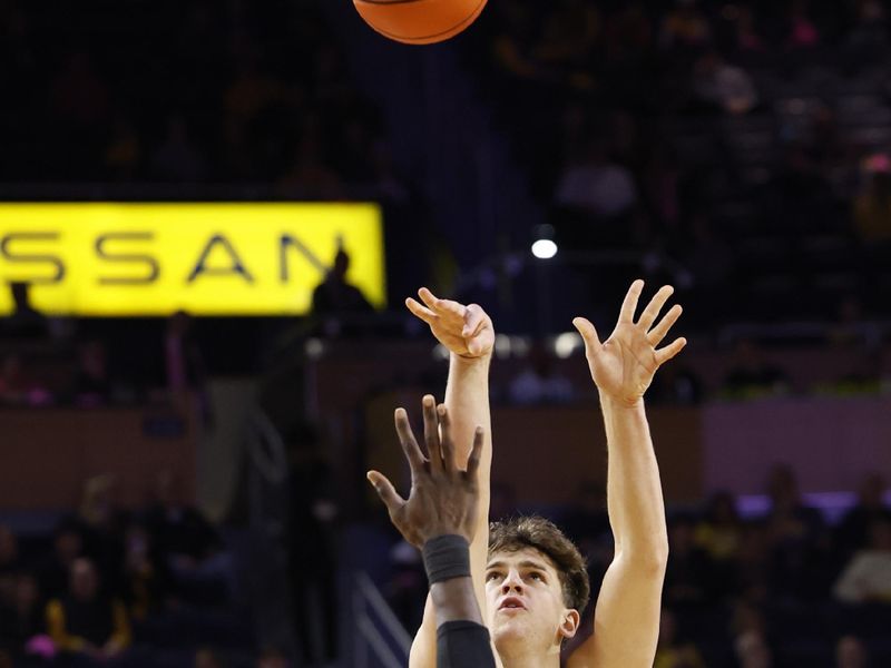 Feb 3, 2024; Ann Arbor, Michigan, USA;  Michigan Wolverines forward Will Tschetter (42) shoots on Rutgers Scarlet Knights center Clifford Omoruyi (11) in the first half at Crisler Center. Mandatory Credit: Rick Osentoski-USA TODAY Sports