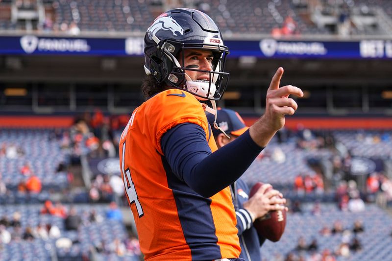 Denver Broncos quarterback Jarrett Stidham (4) warms up before an NFL football game between the Denver Broncos and the Los Angeles Chargers, Sunday, Dec. 31, 2023, in Denver. (AP Photo/Jack Dempsey)