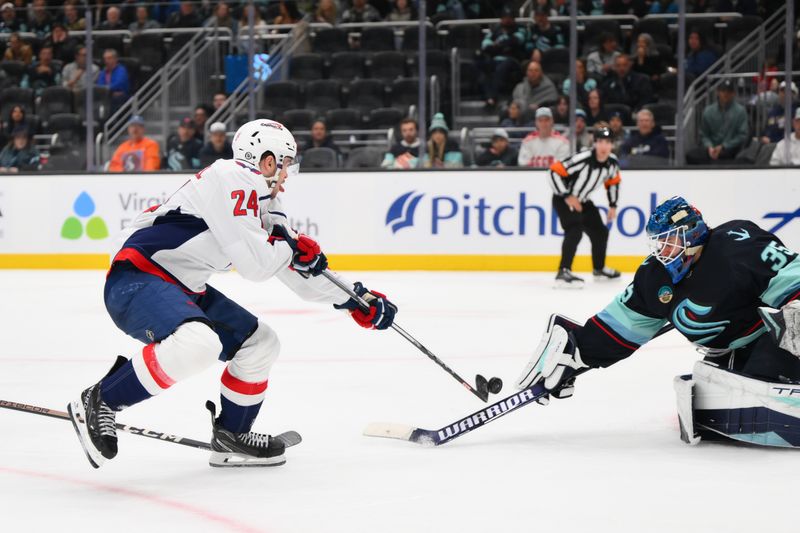 Mar 14, 2024; Seattle, Washington, USA; Seattle Kraken goaltender Joey Daccord (35) blocks a goal shot by Washington Capitals center Connor McMichael (24) during the third period at Climate Pledge Arena. Mandatory Credit: Steven Bisig-USA TODAY Sports