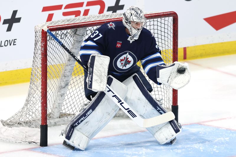 Dec 14, 2024; Winnipeg, Manitoba, CAN; Winnipeg Jets goaltender Connor Hellebuyck (37) warms up before a game against the Montreal Canadiens at Canada Life Centre. Mandatory Credit: James Carey Lauder-Imagn Images