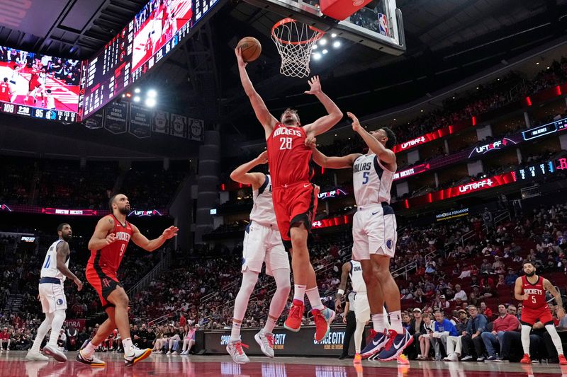HOUSTON, TX - JANUARY 1:  Alperen Sengun #28 of the Houston Rockets drives to the basket during the game against the Dallas Mavericks on January 1, 2025 at the Toyota Center in Houston, Texas. NOTE TO USER: User expressly acknowledges and agrees that, by downloading and or using this photograph, User is consenting to the terms and conditions of the Getty Images License Agreement. Mandatory Copyright Notice: Copyright 2025 NBAE (Photo by Kevin M. Cox/NBAE via Getty Images)