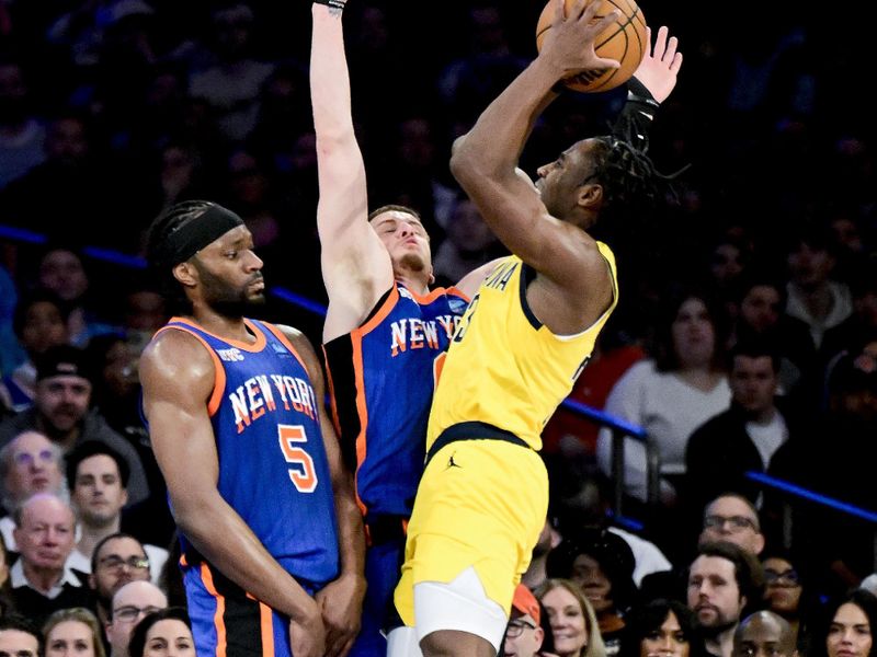 NEW YORK, NEW YORK - FEBRUARY 10:  Aaron Nesmith #23 of the Indiana Pacers drives to the basket against Donte DiVincenzo #0 and Precious Achiuwa #5 of the New York Knicks during the second half at Madison Square Garden on February 10, 2024 in New York City. NOTE TO USER: User expressly acknowledges and agrees that, by downloading and or using this photograph, User is consenting to the terms and conditions of the Getty Images License Agreement. (Photo by Steven Ryan/Getty Images)