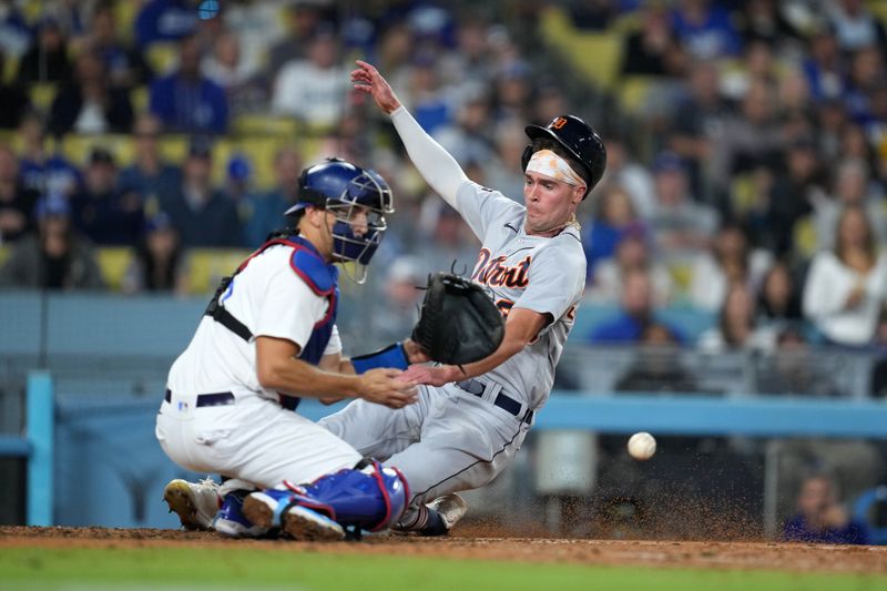 Sep 20, 2023; Los Angeles, California, USA; Detroit Tigers right fielder Kerry Carpenter (30) slides into home plate to beat a throw to Los Angeles Dodgers catcher Austin Barnes (15) to score in the eighth inning at Dodger Stadium. Mandatory Credit: Kirby Lee-USA TODAY Sports