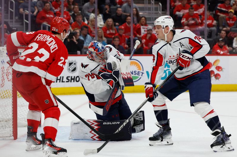 Apr 9, 2024; Detroit, Michigan, USA;  Washington Capitals goaltender Charlie Lindgren (79) makes a save in front of Detroit Red Wings left wing Lucas Raymond (23) and defenseman John Carlson (74) in the second period at Little Caesars Arena. Mandatory Credit: Rick Osentoski-USA TODAY Sports