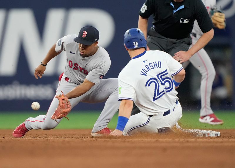 Jun 18, 2024; Toronto, Ontario, CAN; Toronto Blue Jays center fielder Daulton Varsho (25) steals second base against Boston Red Sox second baseman Enmanuel Valdez (47) during the sixth inning at Rogers Centre. Mandatory Credit: John E. Sokolowski-USA TODAY Sports