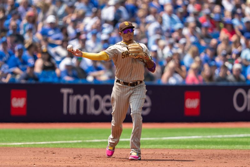 Jul 20, 2023; Toronto, Ontario, CAN; San Diego Padres third baseman Manny Machado (13) throws to first base against the Toronto Blue Jays during the second inning at Rogers Centre. Mandatory Credit: Kevin Sousa-USA TODAY Sports