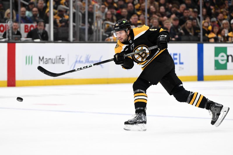 Nov 3, 2024; Boston, Massachusetts, USA; Boston Bruins defenseman Andrew Peeke (52) takes a shot against the Seattle Kraken during the first period at the TD Garden. Mandatory Credit: Brian Fluharty-Imagn Images
