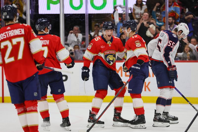 Apr 11, 2024; Sunrise, Florida, USA; Florida Panthers center Evan Rodrigues (17) celebrates with center Anton Lundell (15) after scoring against the Columbus Blue Jackets during the second period at Amerant Bank Arena. Mandatory Credit: Sam Navarro-USA TODAY Sports