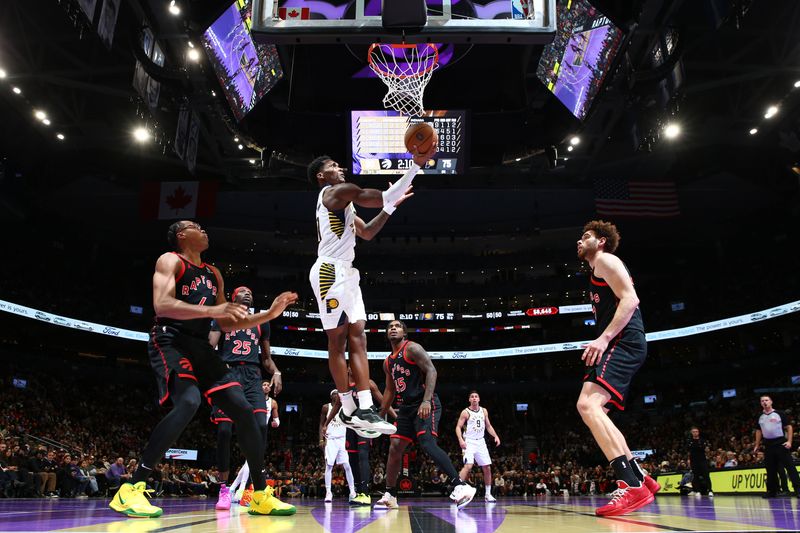 TORONTO, CANADA - DECEMBER 3: Bennedict Mathurin #00 of the Indiana Pacers drives to the basket during the game against the Toronto Raptors during the Emirates NBA Cup game on December 3, 2024 at the Scotiabank Arena in Toronto, Ontario, Canada.  NOTE TO USER: User expressly acknowledges and agrees that, by downloading and or using this Photograph, user is consenting to the terms and conditions of the Getty Images License Agreement.  Mandatory Copyright Notice: Copyright 2024 NBAE (Photo by Vaughn Ridley/NBAE via Getty Images)