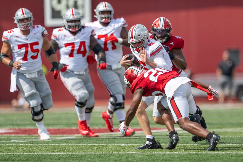 Sep 2, 2023; Bloomington, Indiana, USA; Ohio State Buckeyes quarterback Kyle McCord (6) is tackled by Indiana Hoosiers defensive back Louis Moore (20) during the first quarter at Memorial Stadium. Mandatory Credit: Marc Lebryk-USA TODAY Sports