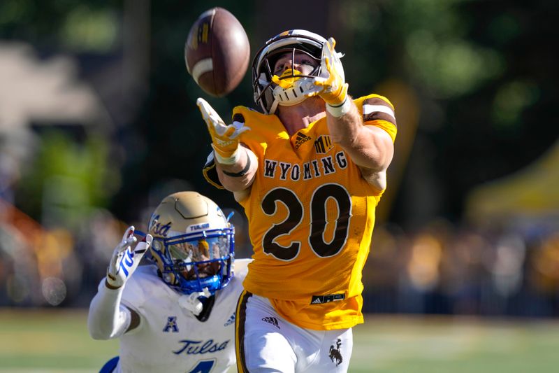 Sep 3, 2022; Laramie, Wyoming, USA; Wyoming Cowboys wide receiver Ryan Marquez (20) reaches for the ball against the Tulsa Golden Hurricane during the fourth quarter at Jonah Field at War Memorial Stadium. Mandatory Credit: Troy Babbitt-USA TODAY Sports