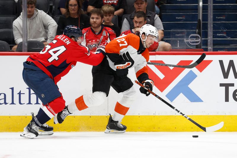 Sep 22, 2024; Washington, District of Columbia, USA; Philadelphia Flyers forward Noah Cates (27) skates with the puck as Washington Capitals defenseman Cam Allen (54) defends in the second period at Capital One Arena. Mandatory Credit: Geoff Burke-Imagn Images