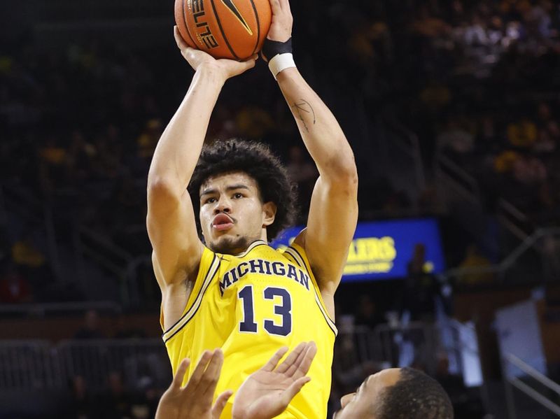 Jan 15, 2024; Ann Arbor, Michigan, USA; Michigan Wolverines forward Olivier Nkamhoua (13) shoots over Ohio State Buckeyes forward Zed Key (23) in the first half at Crisler Center. Mandatory Credit: Rick Osentoski-USA TODAY Sports