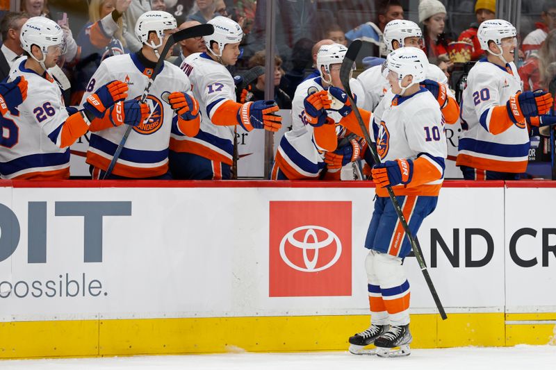 Nov 29, 2024; Washington, District of Columbia, USA; New York Islanders right wing Simon Holmstrom (10) celebrates with teammates after scoring a goal against the Washington Capitals in the first period at Capital One Arena. Mandatory Credit: Geoff Burke-Imagn Images