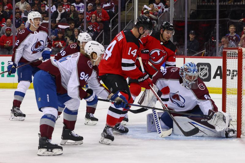 Feb 6, 2024; Newark, New Jersey, USA; Colorado Avalanche goaltender Justus Annunen (60) makes a save on New Jersey Devils right wing Nathan Bastian (14) during the second period at Prudential Center. Mandatory Credit: Ed Mulholland-USA TODAY Sports