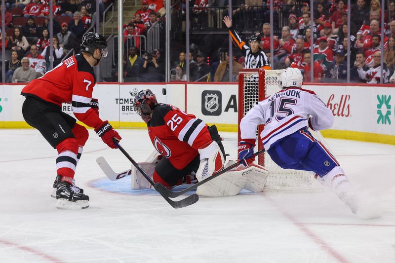 Nov 7, 2024; Newark, New Jersey, USA; Montreal Canadiens center Alex Newhook (15) scores a goal on New Jersey Devils goaltender Jacob Markstrom (25) during the third period at Prudential Center. Mandatory Credit: Ed Mulholland-Imagn Images