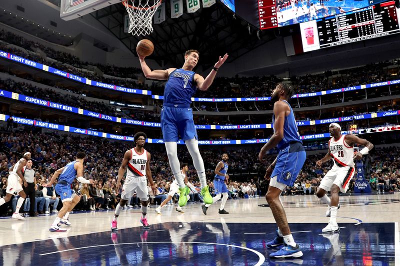 DALLAS, TEXAS - JANUARY 05: Dwight Powell #7 of the Dallas Mavericks grabs a rebound against the Portland Trail Blazers in the first half at American Airlines Center on January 05, 2024 in Dallas, Texas. NOTE TO USER: User expressly acknowledges and agrees that, by downloading and or using this photograph, User is consenting to the terms and conditions of the Getty Images License Agreement. (Photo by Tim Heitman/Getty Images)