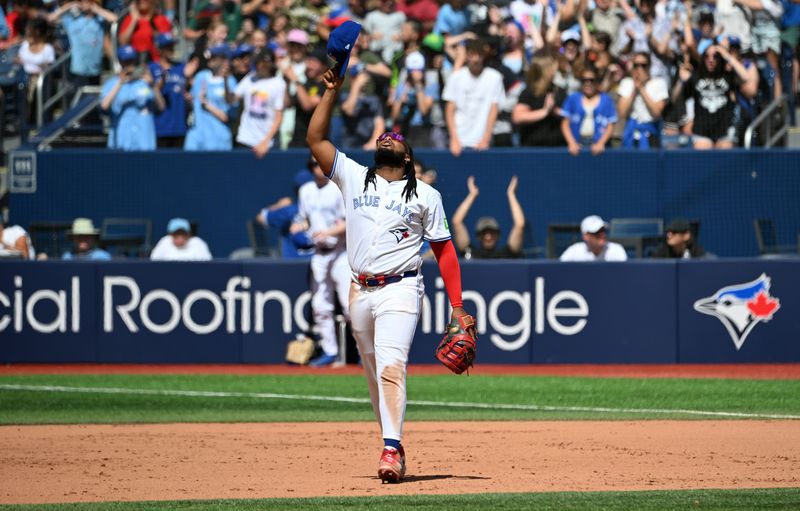 Jun 6, 2024; Toronto, Ontario, CAN;   Toronto Blue Jays first baseman Vladimir Guerrero Jr. (27) celebrates a win over the Baltimore Orioles at Rogers Centre. Mandatory Credit: Dan Hamilton-USA TODAY Sports