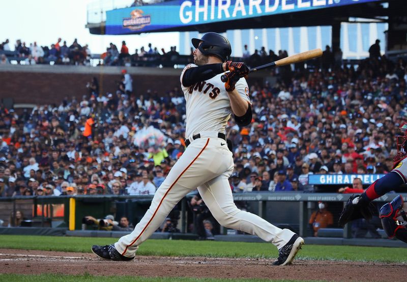 Aug 27, 2023; San Francisco, California, USA; San Francisco Giants center fielder Austin Slater (13) hits a single Atlanta Braves during the fifth inning at Oracle Park. Mandatory Credit: Kelley L Cox-USA TODAY Sports