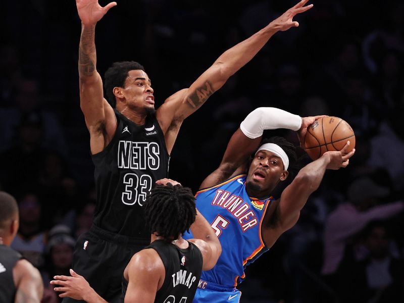 NEW YORK, NEW YORK - JANUARY 05:  Nic Claxton #33 of the Brooklyn Nets defends against Luguentz Dort #5 of the Oklahoma City Thunder during their game at Barclays Center on January 05, 2024 in New York City.  User expressly acknowledges and agrees that, by downloading and or using this photograph, User is consenting to the terms and conditions of the Getty Images License Agreement.   (Photo by Al Bello/Getty Images)