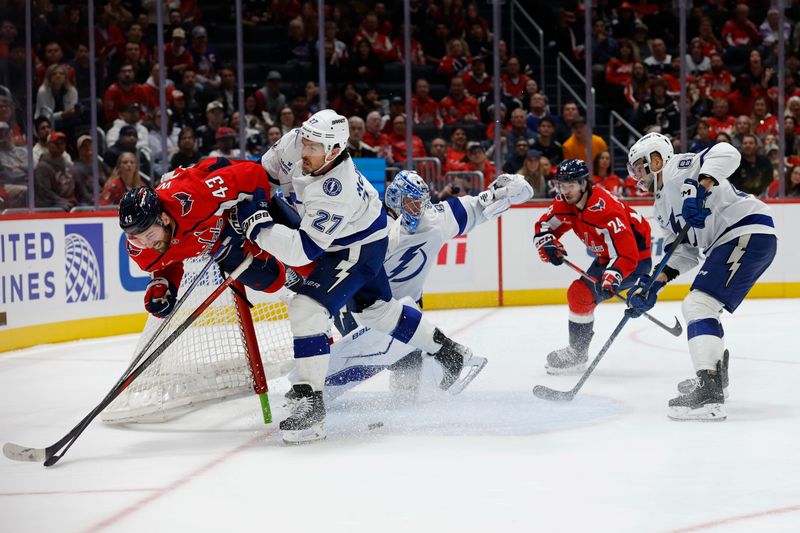 Oct 14, 2025; Washington, District of Columbia, USA; Washington Capitals right wing Tom Wilson (43) crashes into the net after colliding with Tampa Bay Lightning goaltender Andrei Vasilevskiy (88) and Lightning defenseman Ryan McDonagh (27) while attempting a shot on goal in the third period at Capital One Arena. Mandatory Credit: Geoff Burke-Imagn Images