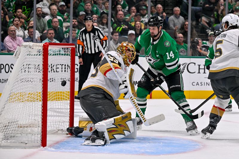 Mar 10, 2026; Dallas, Texas, USA; Dallas Stars left wing Jamie Benn (14) redirects the puck past Vegas Golden Knights goaltender Adin Hill (33) during the second period at the American Airlines Center. Mandatory Credit: Jerome Miron-Imagn Images
