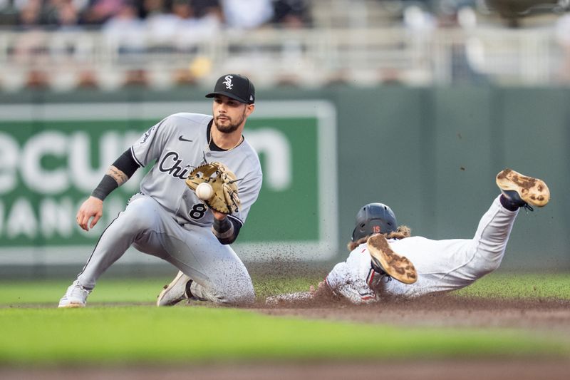 Apr 23, 2025; Minneapolis, Minnesota, USA; The throw to Chicago White Sox shortstop Jacob Amaya (8) is late as Minnesota Twins second base Luke Keaschall (15) slides safe into second base in the third inning at Target Field. Mandatory Credit: Matt Blewett-Imagn Images