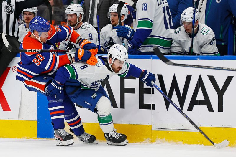 May 14, 2024; Edmonton, Alberta, CAN; Edmonton Oilers forward Corey Perry (90) checks Vancouver Canucks forward Conor Garland (8) during the second period in game four of the second round of the 2024 Stanley Cup Playoffs at Rogers Place. Mandatory Credit: Perry Nelson-USA TODAY Sports