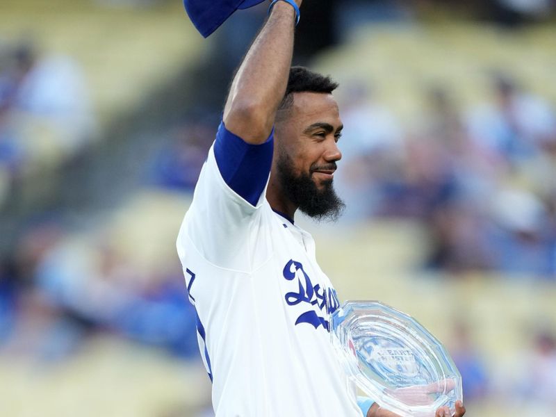 Aug 21, 2024; Los Angeles, California, USA; Los Angeles Dodgers left fielder Teoscar Hernandez (37) poses with the Heart & Hustle Award presented by the Major League Baseball Players Alumni Association during the game against the Seattle Mariners at Dodger Stadium. Mandatory Credit: Kirby Lee-USA TODAY Sports