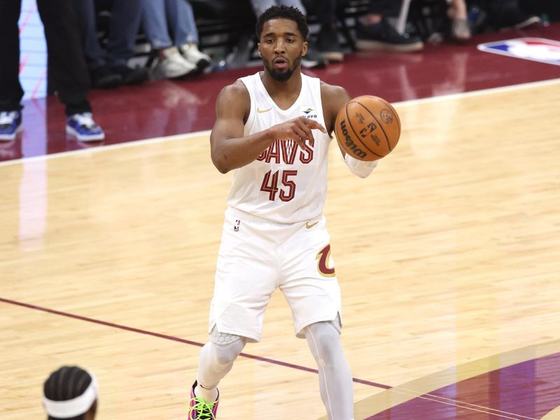 CLEVELAND, OH - APRIL 20: Donovan Mitchell #45 of the Cleveland Cavaliers passes the ball during Round One Game One of the 2024 NBA Playoffs against the Orlando Magic on April 20, 2024 at Rocket Mortgage FieldHouse in Cleveland, Ohio. NOTE TO USER: User expressly acknowledges and agrees that, by downloading and/or using this Photograph, user is consenting to the terms and conditions of the Getty Images License Agreement. Mandatory Copyright Notice: Copyright 2024 NBAE (Photo by  Lauren Leigh Bacho/NBAE via Getty Images)