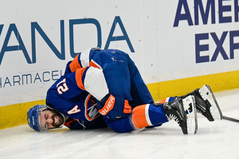 Nov 28, 2025; Elmont, New York, USA; New York Islanders center Kyle Palmieri (21) falls to the ice after an injury against the Philadelphia Flyers during the second period at UBS Arena. Mandatory Credit: Dennis Schneidler-Imagn Images