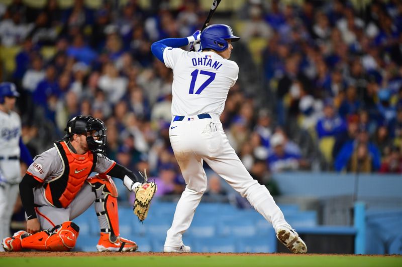 Apr 3, 2024; Los Angeles, California, USA; Los Angeles Dodgers designated hitter Shohei Ohtani (17) hits against the San Francisco Giants during the fourth inning at Dodger Stadium. Mandatory Credit: Gary A. Vasquez-USA TODAY Sports