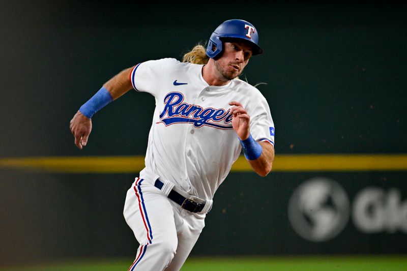 Aug 3, 2023; Arlington, Texas, USA; Texas Rangers left fielder Travis Jankowski (16) runs to third base during the second inning against the Chicago White Sox at Globe Life Field. Mandatory Credit: Jerome Miron-USA TODAY Sports