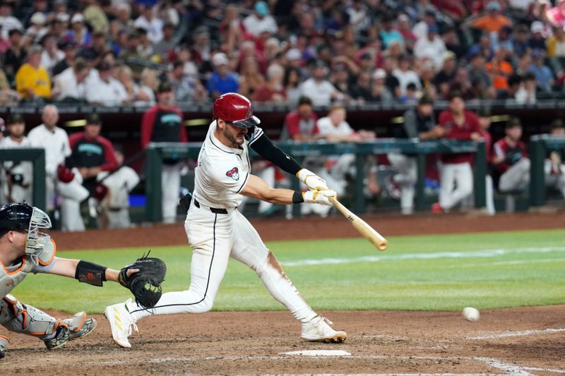 May 19, 2024; Phoenix, Arizona, USA; Arizona Diamondbacks shortstop Blaze Alexander (9) hits an RBI single against the Detroit Tigers during the seventh inning at Chase Field. Mandatory Credit: Joe Camporeale-USA TODAY Sports