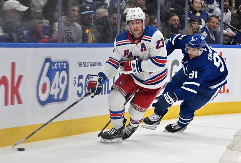 Mar 2, 2024; Toronto, Ontario, CAN;  New York Rangers defenseman Adam Fox (23) skates the puck away from Toronto Maple Leafs forward John Tavares (91) in the third period at Scotiabank Arena. Mandatory Credit: Dan Hamilton-USA TODAY Sports