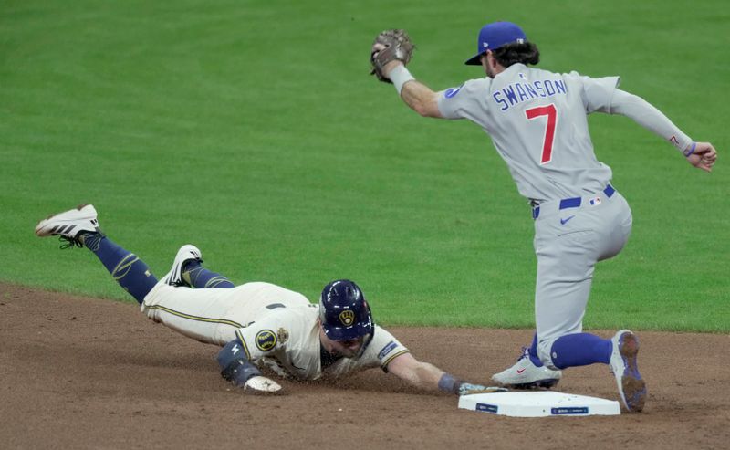 Oct 11, 2025; Milwaukee, Wisconsin, USA; Milwaukee Brewers third baseman Caleb Durbin (21) beats a tag by Chicago Cubs shortstop Dansby Swanson (7) to steal second base during the second inning during game five of the NLDS round for the 2025 MLB playoffs at American Family Field. Mandatory Credit: Mark Hoffman-USA TODAY Network via Imagn Images