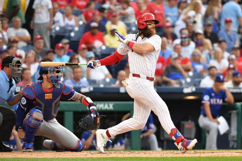 May 22, 2024; Philadelphia, Pennsylvania, USA; Philadelphia Phillies outfielder Brandon Marsh (16) hits an  RBI single against the Texas Rangers during the second inning at Citizens Bank Park. Mandatory Credit: Eric Hartline-USA TODAY Sports