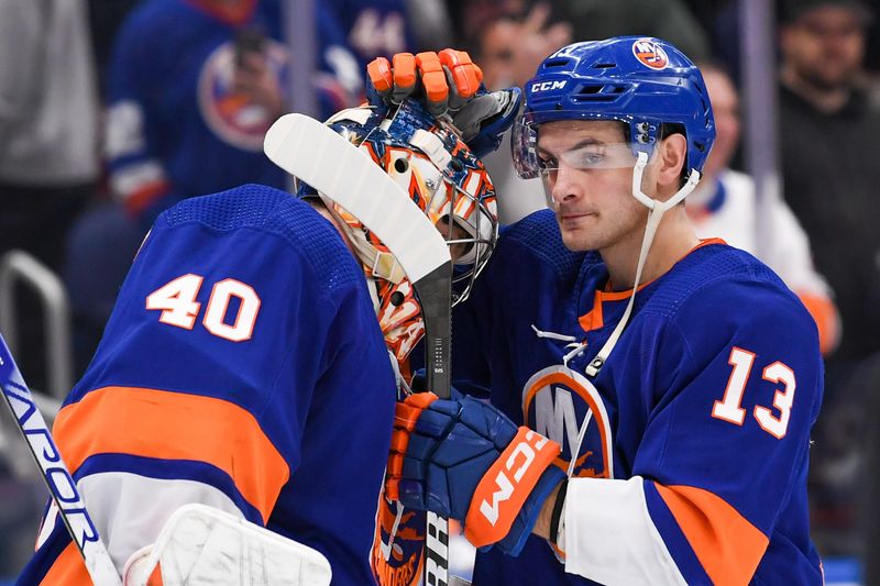 Dec 13, 2023; Elmont, New York, USA; New York Islanders center Mathew Barzal (13) celebrates with New York Islanders goaltender Semyon Varlamov (40) after the 4-3 victory over the Anaheim Ducks after the game at UBS Arena. Mandatory Credit: Dennis Schneidler-USA TODAY Sports